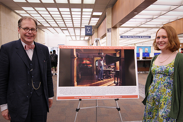 Artist Isabel K. Dunn and image subject Louis Waldman pose by Ms. Dunn's winning image