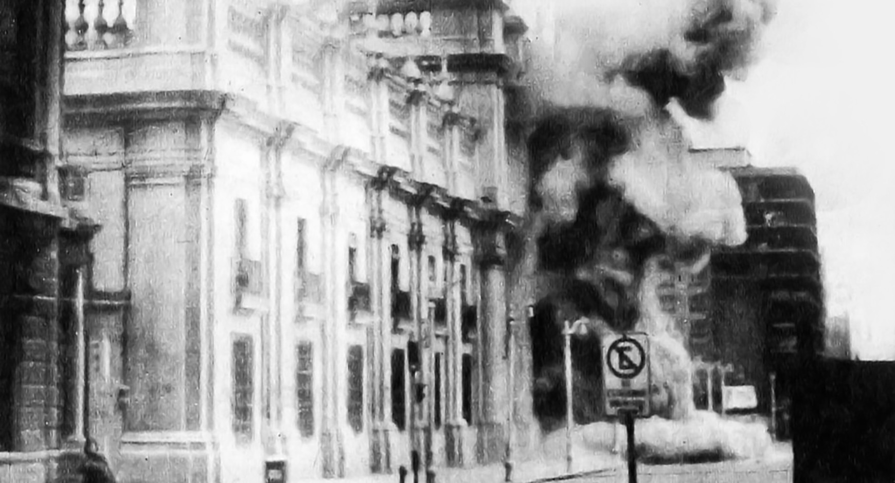 Coup of September 11, 1973. Bombing of La Moneda (presidential palace). Black and white photo of a building exploding into the street.