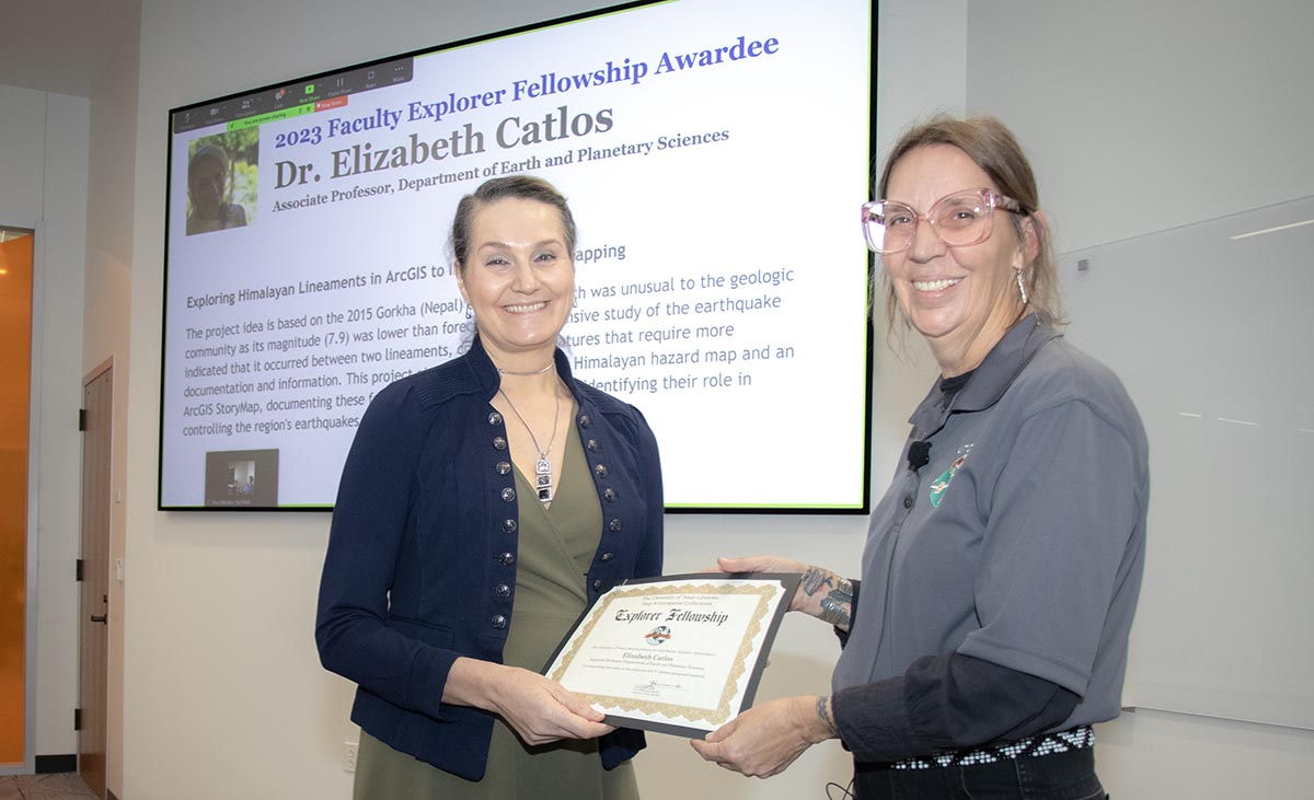 Elizabeth Catlos receiving award from Maps Coordinator Kat Strickland