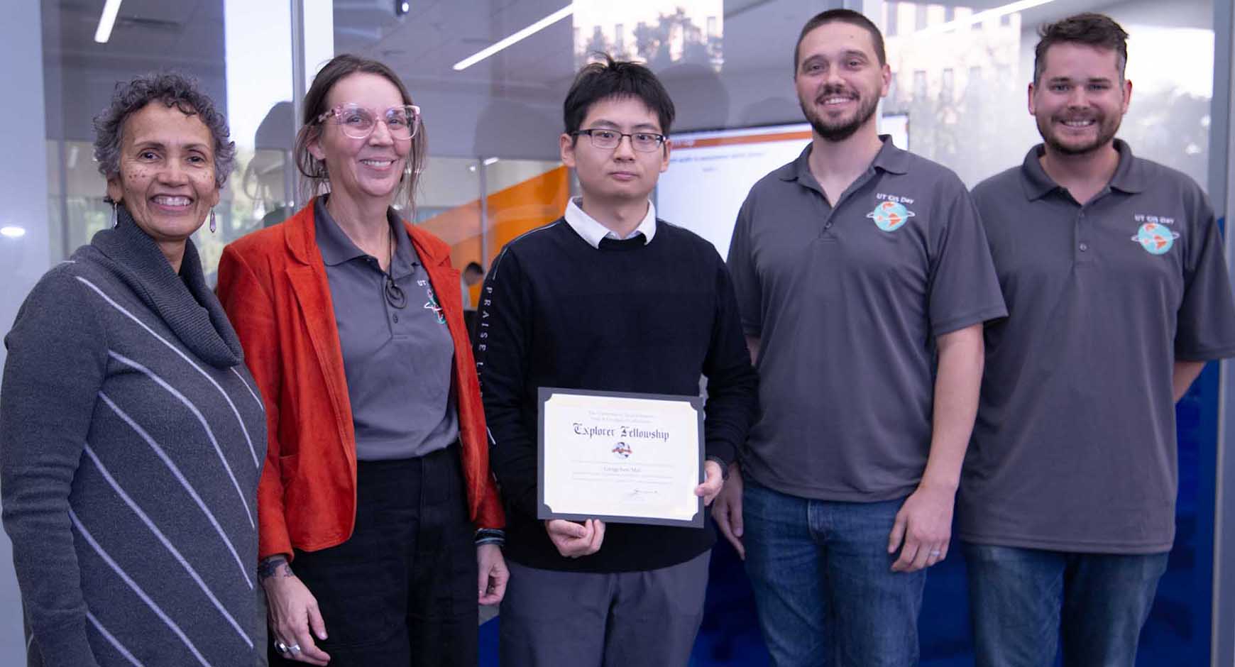 University of Texas Libraries research division staff members pose alongside Libraries Director Lorraine Haricombe (far left) and the 2024 Map & Geospatial Collections Explorer Fellowship faculty winner Dr. Gengchen Mai (center, holding a certificate), celebrating his achievement.