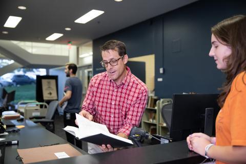 library patron being assisted at a service desk