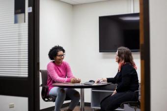 two people in a discussion at a table