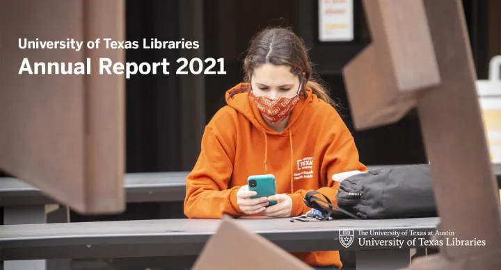 Student sitting outside UT Libraries in a protective face mask looking at phone